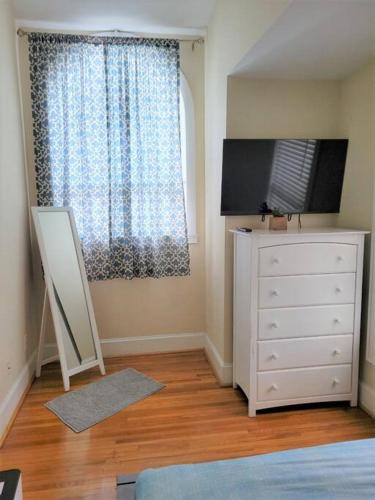 a bedroom with a white dresser and a window at Cozy Center City Cottage*Walk to center city in Charlotte