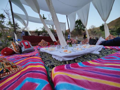 a table set up for a party under a tent at The Jungle Lust in Kumbhalgarh