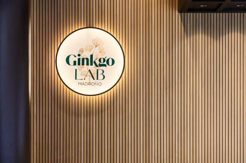 a sign on a wooden wall with a logo on it at VP Madroño in Madrid