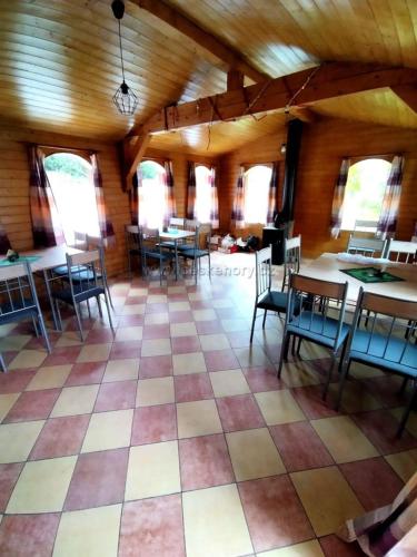 a large room with tables and chairs in a building at Penzion Nikol in Šumperk