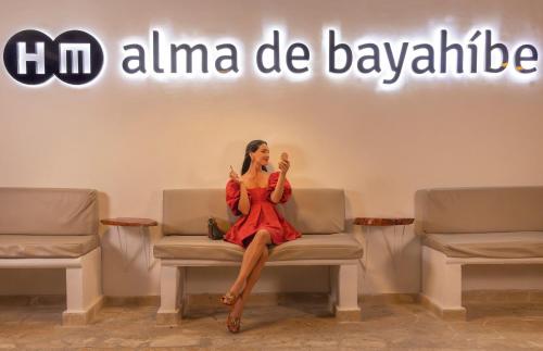 a woman sitting on a chair in a waiting room at HM Alma de Bayahibe - Adults Only in Bayahibe