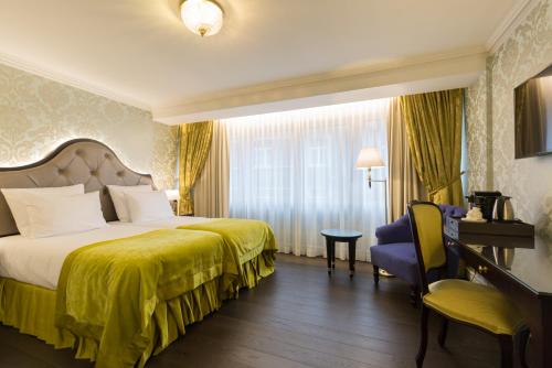 a hotel room with a bed and a chair at Stanhope Hotel by Thon Hotels in Brussels