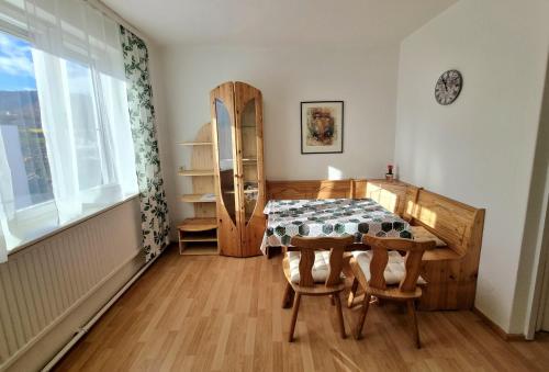 a dining room with a table and a window at Holiday Apartment 2 Villach in Villach