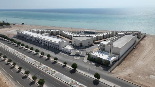 an aerial view of a building near the ocean at YM Resort in Yanbu