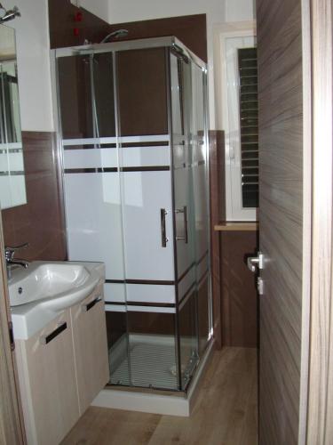 a glass shower in a bathroom with a sink at B&B Verziere in Iesi