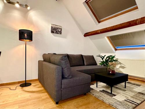 a living room with a couch and a lamp at Luxury Suites Museum by Rikas Hotels in Antwerp