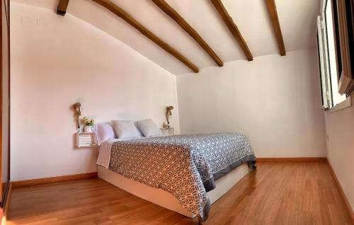 a bedroom with a bed and a wooden floor at Ronko House El Ronquillo in El Ronquillo