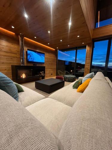 a living room with two couches and a fireplace at Lux 12 in Sierra Nevada