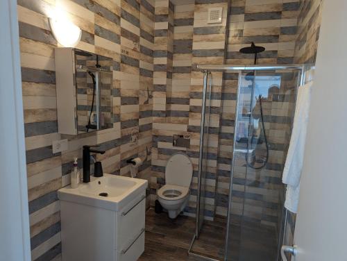 a bathroom with a toilet and a sink and a shower at Black Sea Overlook in Mamaia Sat/Năvodari