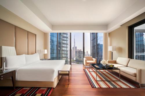 a bedroom with a large bed and a large window at Anantara Downtown Dubai in Dubai