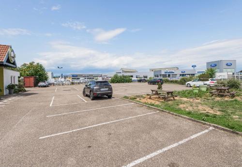 a parking lot with a car parked in it at B&B HOTEL Mulhouse Ile Napoléon in Illzach