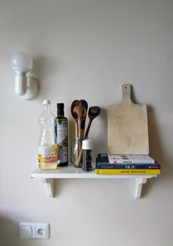 a shelf with various items on a wall at Im Krämerladen in Neustadt an der Weinstraße