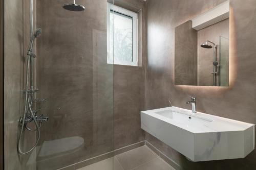 a bathroom with a sink and a shower at Sunset Hill Villa Rhodes in Gennadi
