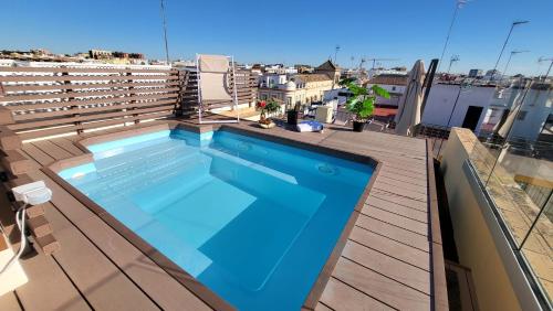 a swimming pool on the roof of a building at RentalSevilla Cardenal Cervantes in Seville