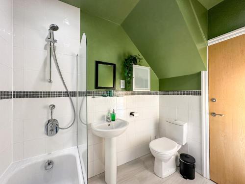 uma casa de banho com um chuveiro, um WC e um lavatório. em 2 Bed - Close to LBU, Headingley Stadium and YCC em Leeds