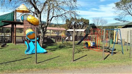 a park with a playground with a swing at Sabie River Camp in Sabie
