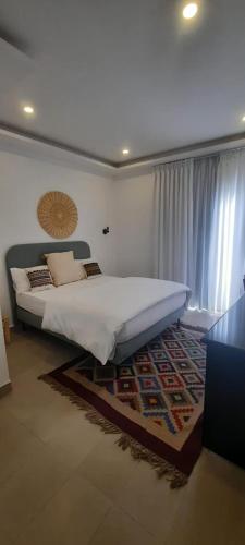 a bedroom with a large bed and a rug at مبنى هلال in Amman
