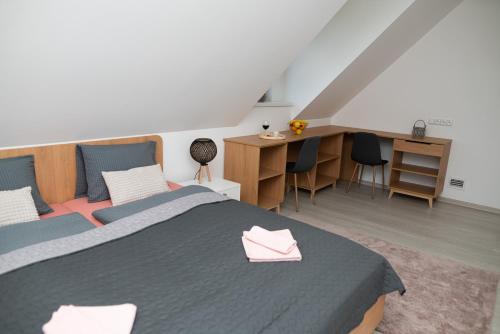 a bedroom with a bed and a desk with chairs at Chalupa U Juzka in Loučná nad Desnou