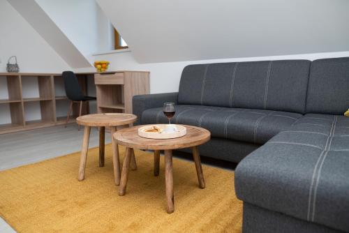 a living room with a couch and two tables at Chalupa U Juzka in Loučná nad Desnou