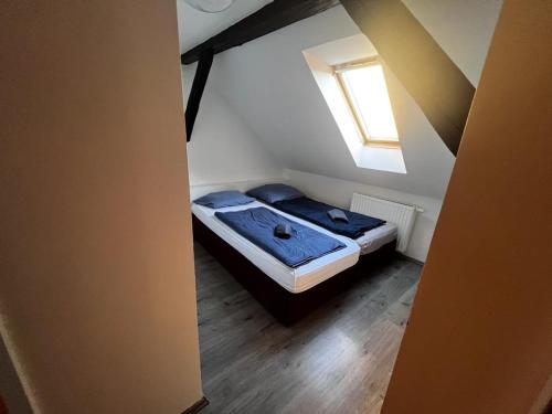 a small bedroom with a bed in a attic at Budget Inn th 23 - Downtown 3 Bedroom apartment in Szombathely