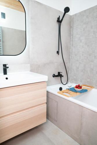 a bathroom with a tub and a sink and a mirror at Chalupa U Juzka in Loučná nad Desnou