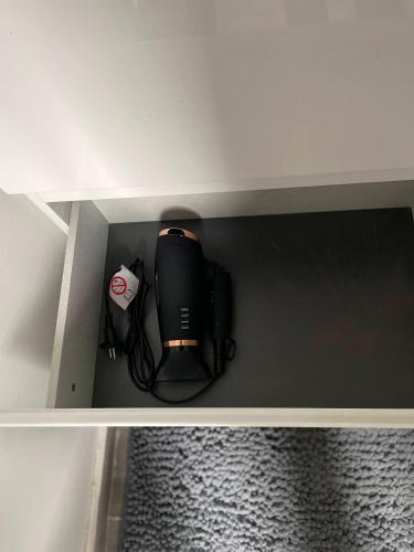 a black router sitting on top of a shelf at Chez Auguy et Deborah in Antwerp