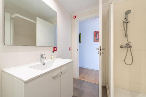 a bathroom with a sink and a shower at Antic 302 in S'Illot