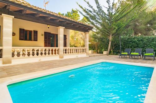 a swimming pool in front of a house at Pomeres 9 in Sa Coma