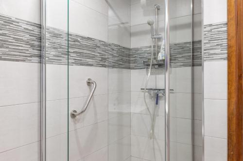 a shower with a glass door in a bathroom at Casa Coral Beach in Málaga