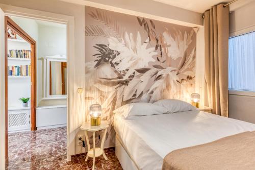 a bedroom with a bed with a floral mural on the wall at Hanami Avenida de España Mountain View 4D in Estepona