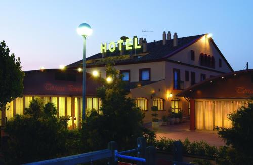 a hotel building with a sign on top of it at Hotel Restaurant Sol i Vi in Lavern