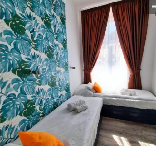 a bedroom with two beds and a window at Centrum Wellness Hostel in Debrecen