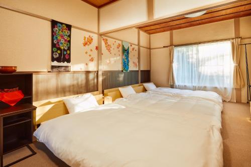 Postelja oz. postelje v sobi nastanitve Villa Hakone Kabuto 古民家旅館 150平米 バス停迄一分 準天然温泉 最大12名