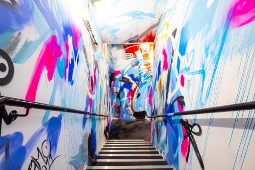 a hallway with a staircase covered in graffiti at The People - Marseille in Marseille