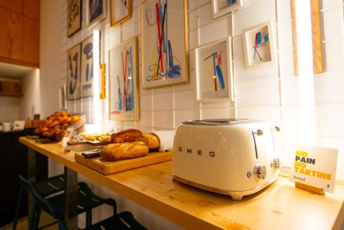 a toaster sitting on top of a counter with bread at The People - Marseille in Marseille