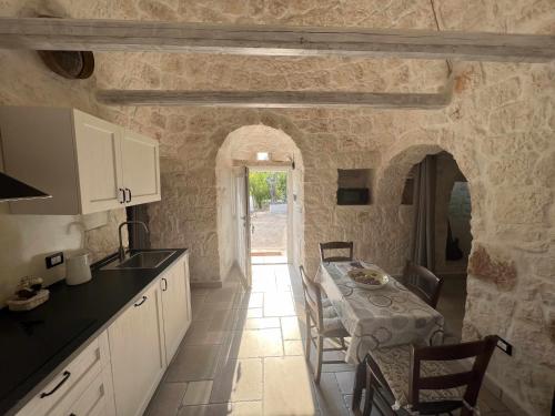 a kitchen and dining room with a table and chairs at RocknTrullo 2 bedroom by TripOstuni in Ostuni