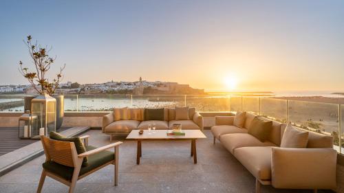 a living room with a couch and a table at Fairmont La Marina Rabat Sale Hotel in Rabat