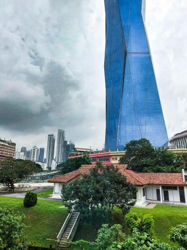 a tall building with a blue reflection on it at Yu Hotel Chinatown in Kuala Lumpur