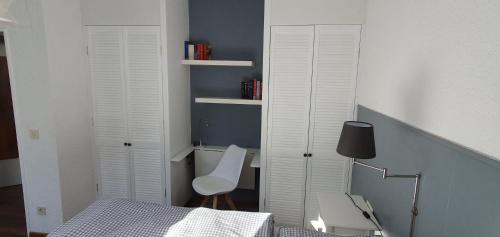 a bedroom with two white closet doors and a bed at Five Seasons in Oberstaufen