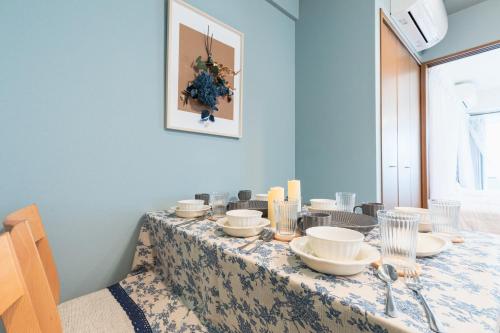 a table with plates and bowls on top of it at HARMONIA東京堀切403 in Tokyo