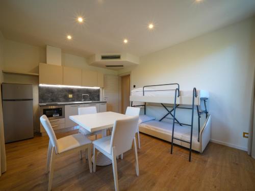 a room with a table and a bunk bed at Castiglioncello Suite in Castiglioncello