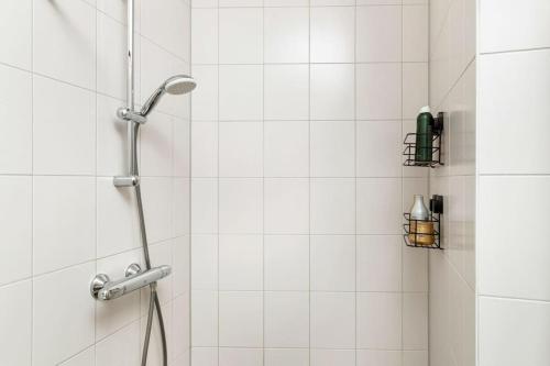 a shower with a shower head in a bathroom at Atmospheric apartment Zaandam/Amsterdam in Zaandam