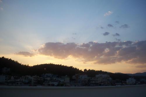 a view of a city from the water at sunset at Hotel Iliana in Filippiada