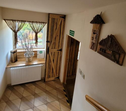 a hallway with a door and a window with a plant at Agroturystyka Sielska Kraina in Ząbkowice Śląskie