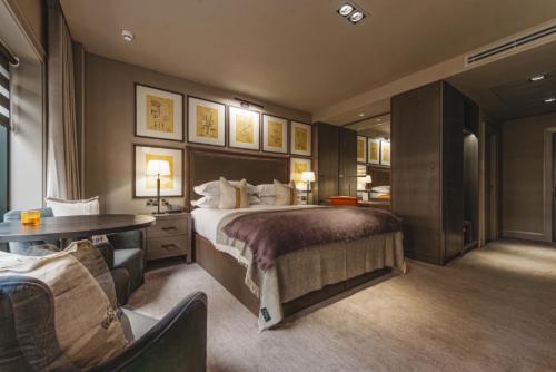 a hotel room with a large bed and a desk at Dakota Leeds in Leeds