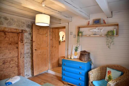 a room with a blue dresser and a blue cabinet at Maison au coeur des Bauges in Aillon-le-Jeune