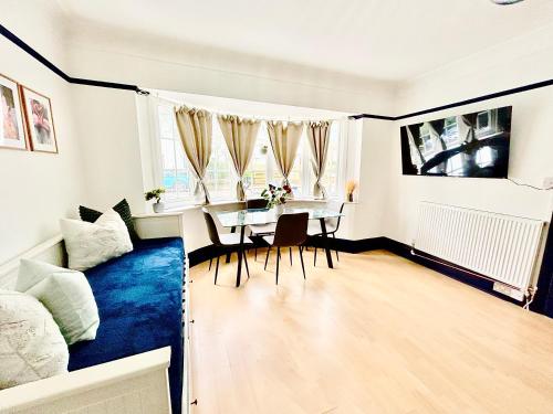 a living room with a table and a couch at Rest Boutique Golders Green in London