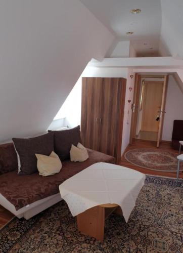 una sala de estar con un sofá y una mesa en Pension Birgit, en Rothenburg ob der Tauber