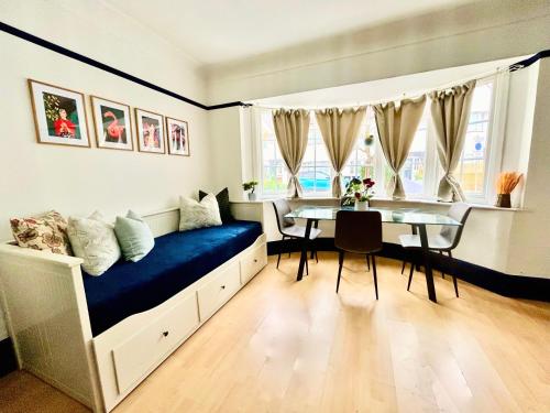 a bedroom with a bed and a table in it at Rest Boutique Golders Green in London
