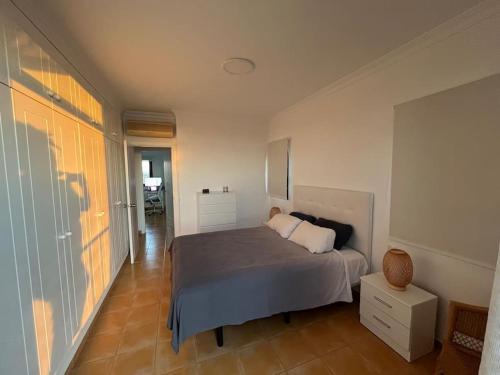a bedroom with a large bed and a hallway at Triplex Meloneras-Amplio,soleado in Maspalomas